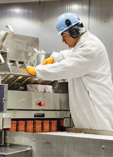 Meat processor packing employee